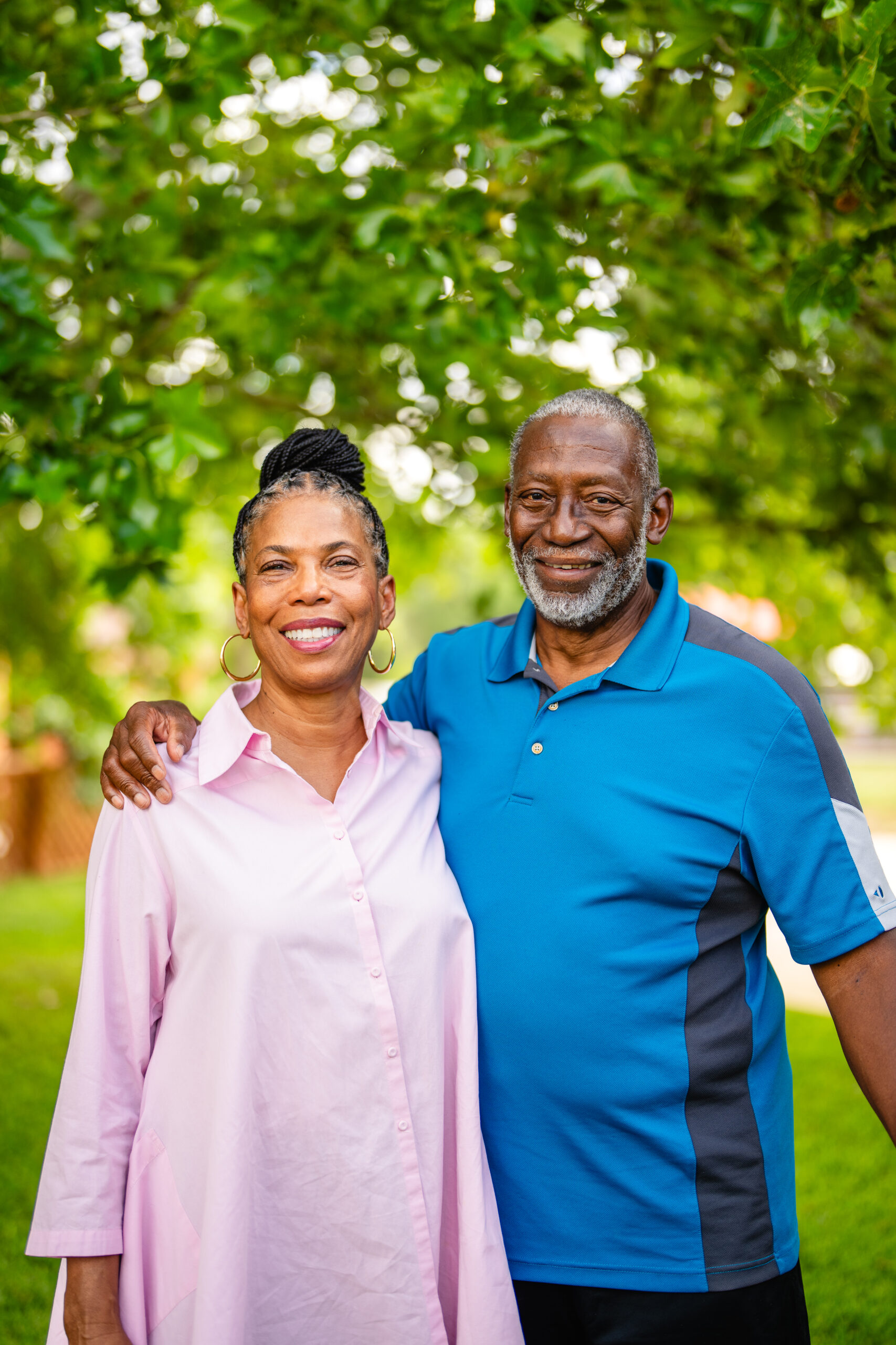 Older couple smiling out side in the park